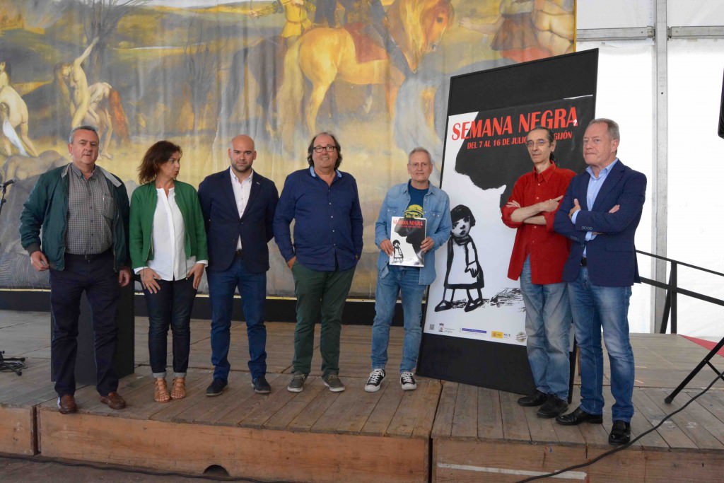 Miembros de la organización de la Semana Negra y representantes institucionales junto al cartel de su trigésima edición, obra de Carme Solé Vendrell, durante el encuentro con los medios celebrado en la Carpa del Encuentro. Fotografía: Merche Medina.